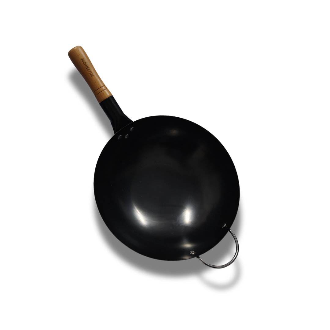 A large carbon steel wok with a wooden handle.